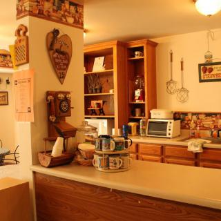A cozy kitchen with vintage decor and wooden cabinets, featuring retro appliances.
