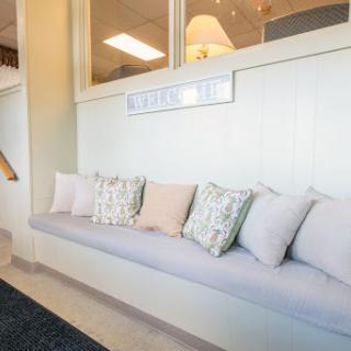 A cozy seating area featuring a sleek bench adorned with decorative pillows, perfect for relaxation.