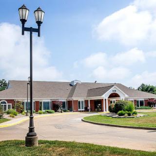 A well-maintained building with a clean entrance and decorative landscaping.