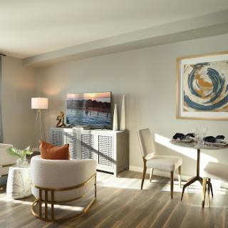 A cozy and modern living room setup featuring stylish furniture, vibrant artwork, and a warm ambiance.