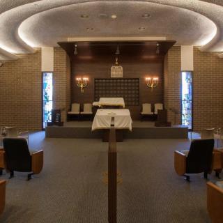 Interior of a synagogue with seating and an altar.