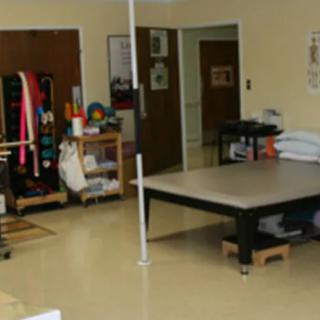A physical therapy room equipped with various exercise and rehabilitation tools.