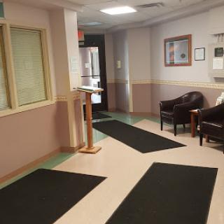 A quiet waiting area with comfortable seating and a reception desk.