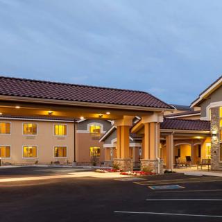 The exterior of a hotel building illuminated at night.