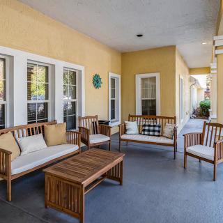 A cozy outdoor patio with wooden furniture and comfortable seating.