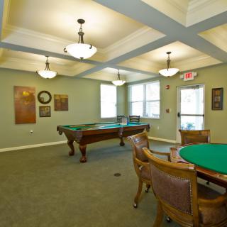 A recreational game room featuring a pool table and seating area.