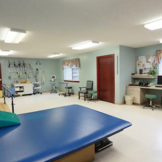 A spacious and well-equipped physical therapy room designed for rehabilitation and treatment.