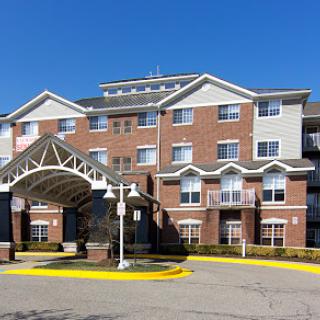 A modern hotel building featuring brick architecture and a welcoming entrance.