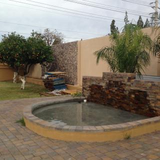 A garden with a water feature and landscaping.