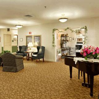 A cozy living area with a piano and comfortable seating.