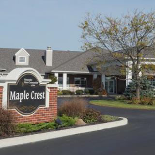 Entrance to Maple Crest with a welcoming driveway and well-maintained landscaping.