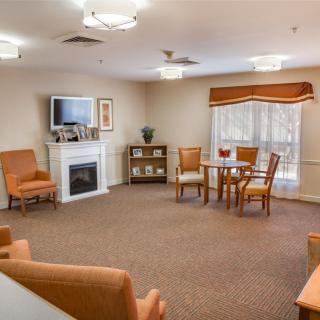 A cozy living room with a fireplace, television, and comfortable seating.