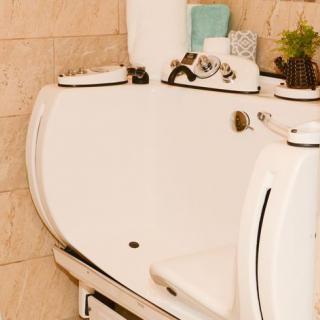 A white walk-in bathtub designed for accessibility in a modern bathroom setting.