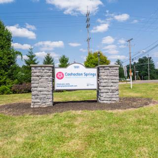A welcoming sign for a community named 'Catawba Springs' set against a clear blue sky.