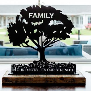 A decorative sign featuring a tree silhouette with the words 'FAMILY' and 'In our roots lies our strength'.