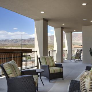 A spacious patio with comfortable seating and a scenic mountain view.