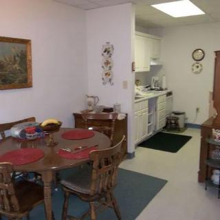 A cozy dining area with a view into the adjoining kitchen.