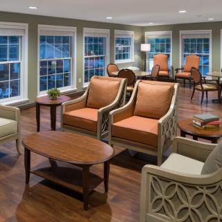 A cozy living room with comfortable seating and large windows.