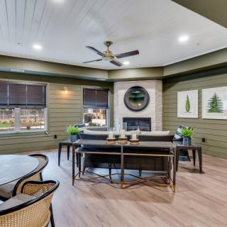 A modern living room featuring a central fireplace, stylish furniture, and elegant decor.