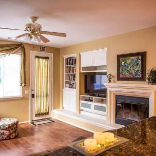 Cozy living room with fireplace and ceiling fan.