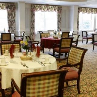 An elegantly decorated dining area with neatly set tables and chairs.