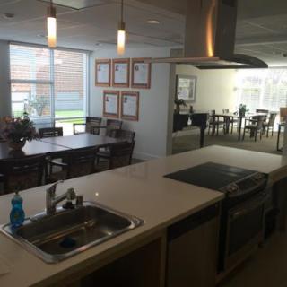 A modern kitchen and dining area featuring a well-equipped cooking space and ample seating.
