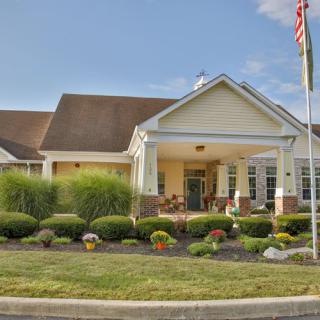 A well-maintained building with a landscaped front yard and flagpole.