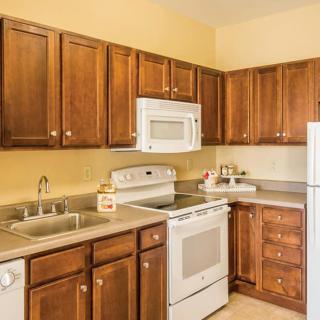A cozy kitchen featuring wooden cabinets and modern appliances.