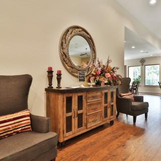 A welcoming living room with elegant wooden furniture and decorative elements.