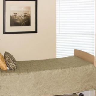 A minimalist bedroom with a single bed, pillow, framed picture, and window blinds.