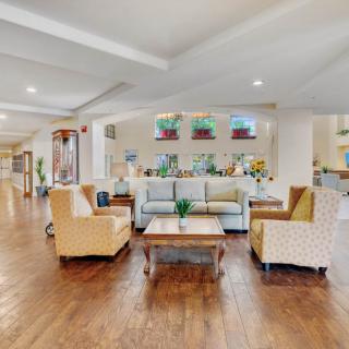 A cozy living room with a modern seating arrangement and hardwood floors.