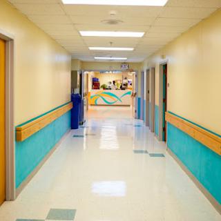 A bright and clean hospital hallway designed for a welcoming atmosphere.