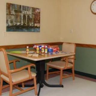 A small room with a table and two chairs, displaying snacks and drinks.