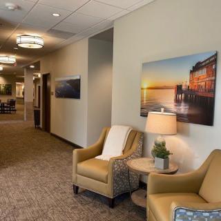 A cozy office lobby with seating and artwork on the walls.