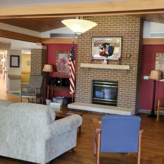 A cozy living room area with a fireplace and comfortable seating.