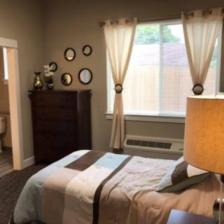 Cozy bedroom with elegant decor and natural lighting.