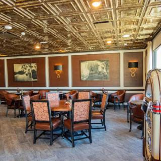 A cozy restaurant interior with decorative wall art and comfortable seating arrangements.
