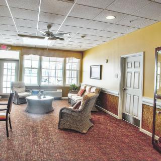 A cozy living room with comfortable seating and large windows.