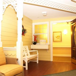 A cozy and warmly lit living room area featuring comfortable seating and decorative elements.