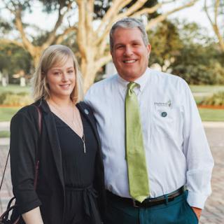 A cheerful couple posing together in a beautiful outdoor setting.