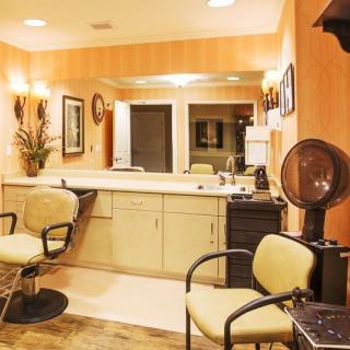 A well-organized hair salon interior with chairs, mirrors, and hairdressing equipment.
