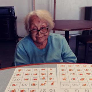 An elderly woman enjoying a game of bingo.