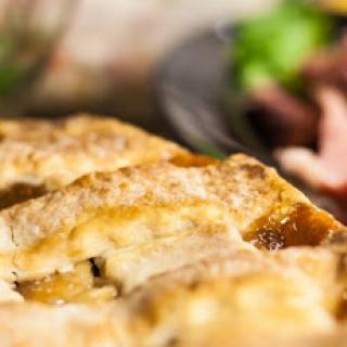 A deliciously golden and flaky pastry served alongside fresh greens.