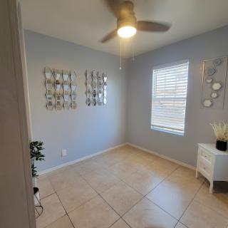 A bright and minimalist room featuring modern decor and wall art.