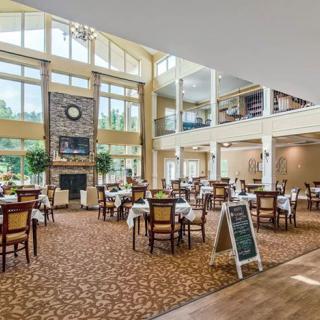 A spacious restaurant with modern decor and large windows offering plenty of natural light.