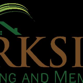 A logo featuring a house design with green accents.