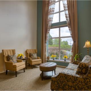 Cozy living room with large windows and elegant furnishings.