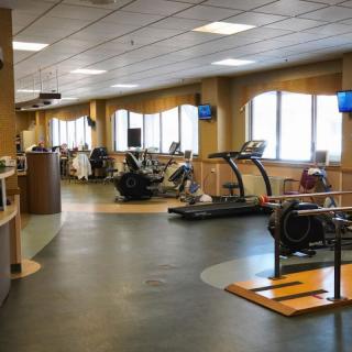 An indoor fitness center with various exercise equipment, including treadmills and stationary bikes.