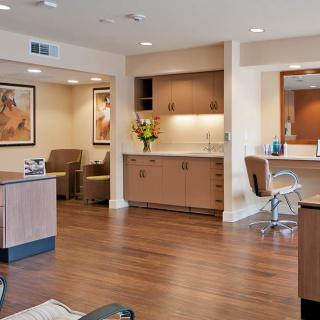 A modern hair salon with stylish furnishings and warm lighting.