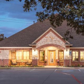 A warmly lit building in the evening with brick architecture.